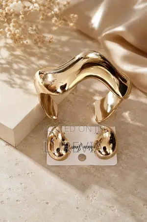 A Chunky Gold Cuff and Matching Earring