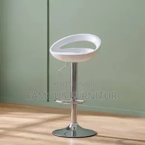 This Is a Modern White Plastic Adjustable-Height Swivel Bar Stool
