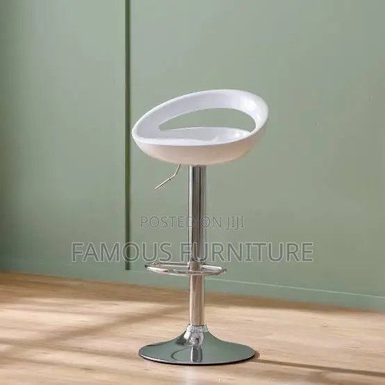 This Is a Modern White Plastic Adjustable-Height Swivel Bar Stool