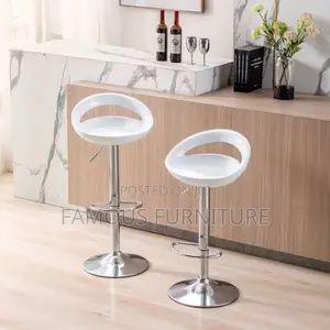 This Is a Modern White Plastic Adjustable-Height Swivel Bar Stool