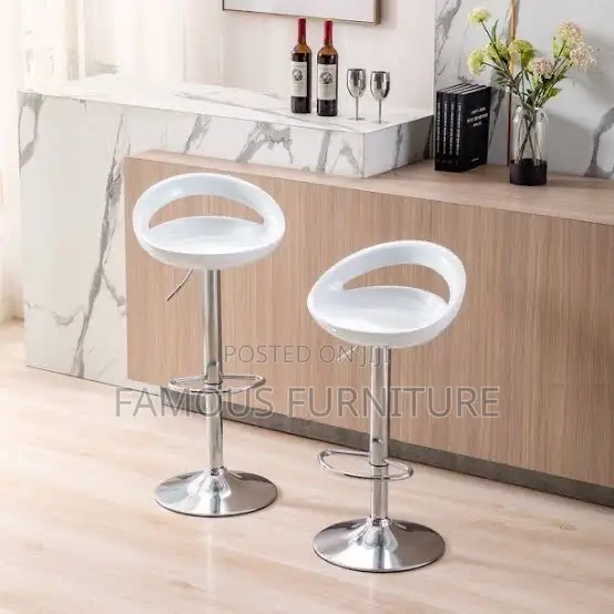 This Is a Modern White Plastic Adjustable-Height Swivel Bar Stool