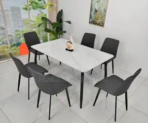 This Is a Modern Six-Seater Dining Set Featuring a Smooth White Marble