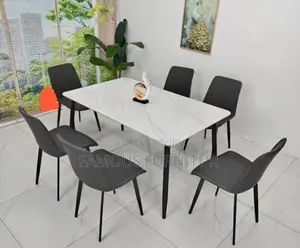 This Is a Modern Six-Seater Dining Set Featuring a Smooth White Marble