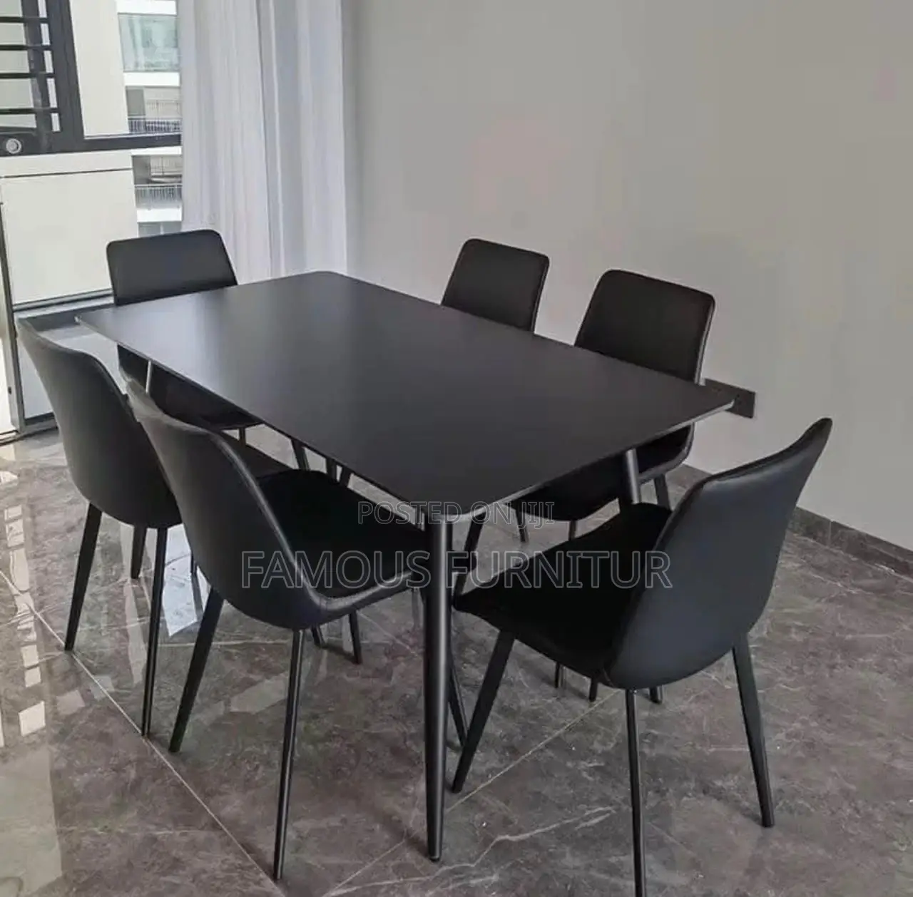 This Is a Modern Six-Seater Dining Set Featuring a Smooth White Marble