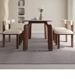 The Image Shows a Modern Minimalist Dining Set With a White Marble-Top