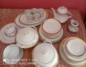 White Porcelain Dinner Service Set Decorated With Gold-Trimmed Rims.