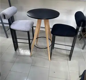 Modern Bar Set Featuring a Round Black-Topped Table Paired Barstools