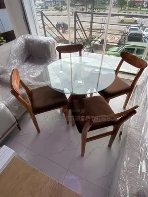 A Round Dining Set With Warm Brown Seating