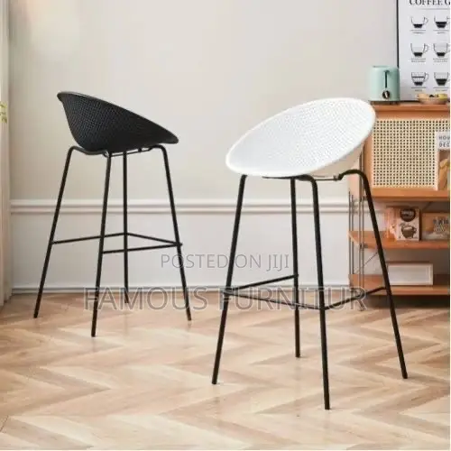 Modern Bar Stools Featuring Curved, Perforated Shell Seats Supported