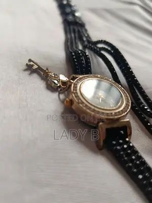 Elegant Black Charm Wristwatch With Gold Clover-Key Charm