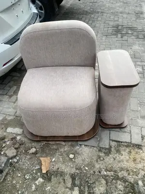 Modern Single Lounge Chair With an Attached Side Table.