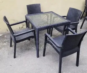 This Appears to Be a Black Rattan-Style Outdoor Dining Set