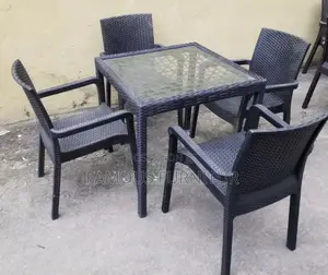 This Appears to Be a Black Rattan-Style Outdoor Dining Set