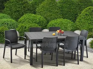 The Image Shows a Black Resin Rattan-Style Outdoor Dining Set