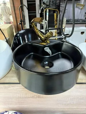 Black Counter Top Basin With Gold Tap.