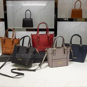 Top-Handle Guess Handbags Feature a Polished Gold-Tone Logo