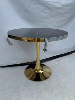 Modern Round Table With a Dark, Faux-Marble Top and a Shiny Gold Base