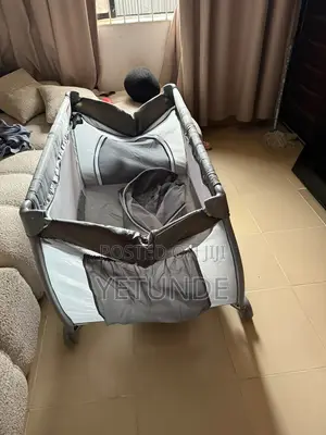A Baby Playpen / Travel Cot (Portable Crib).