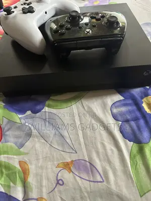 Xbox One X, Two Wired Controllers and Games Installed