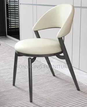 Century Modern Dining Chair Featuring a Cream Faux-Leather Chair