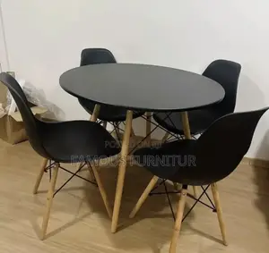 Modern Round Dining Set Featuring a Smooth Black Tabletop Paired