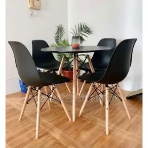 Modern Round Dining Set Featuring a Smooth Black Tabletop Paired