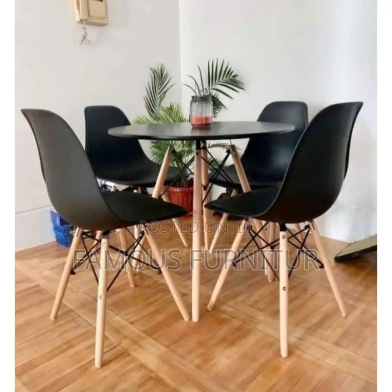 Modern Round Dining Set Featuring a Smooth Black Tabletop Paired