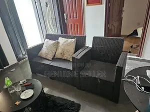 Two Sitter and a Single Rattan Outdoor Lounge Chair.