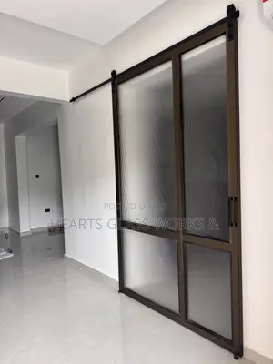 Architectural Barn Door Installed With Quality Frame and Flutted Glass