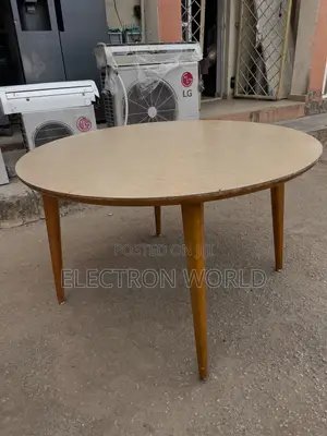 Vintage Round Wooden Table Featuring a Light-Toned Top.