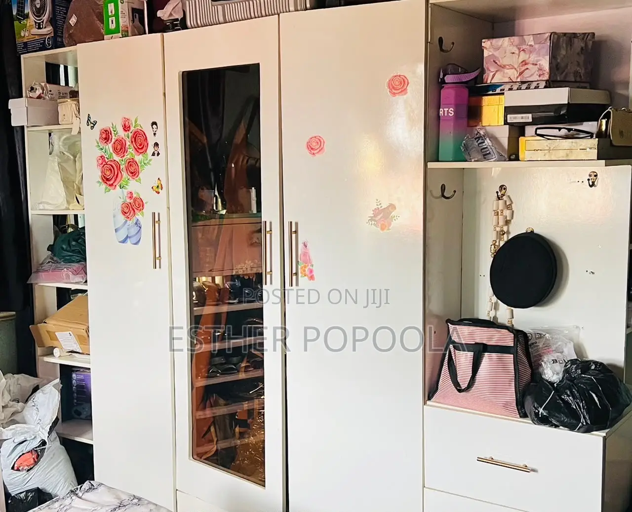 Large White Wooden Wardrobe With Multiple Storage Sections.