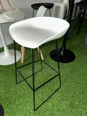Modern White Bar Stool Features a Curved Fiber Seat and a Minimalist
