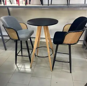 Modern Pub Set With a Round Black Table and Two Woven Rattan