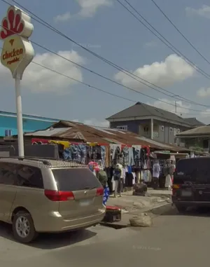 A Bungalow, Consist of Rooms and (8 Units) of Shops, on a Corner Piece