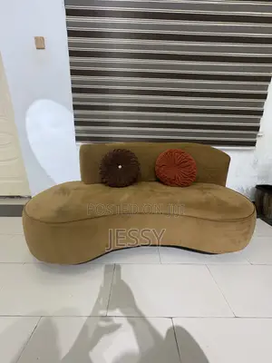 A Newly Used Comfortable Three Seater Sofa With Throw Pillows