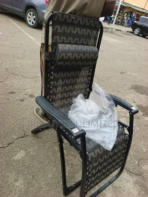 Folding Outdoor Relaxing Lounge Chair With a Patterned Mesh Fabric.