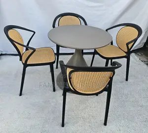 This 4-Seater Round Dining Set Features a Dark Pedestal Table Paired