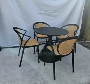 This 4-Seater Round Dining Set Features a Dark Pedestal Table Paired