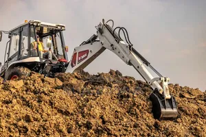 Bobcat B760 Backhoe Loader Digging Into a Mound of Earth