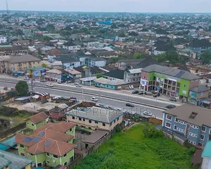 Fenced 5 Plots of Commercial Land on the Busy Ada George Road