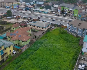 Fenced 5 Plots of Commercial Land on the Busy Ada George Road
