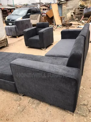 An L Shaped Fabric Sofa With One Single Seater