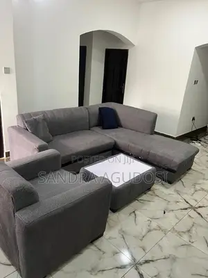 L-Shaped Sofa With Single Chair and Center Table