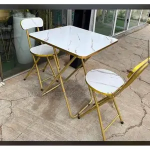 A Marble-Design Foldable Table and Chair Set Featuring a White Faux-M