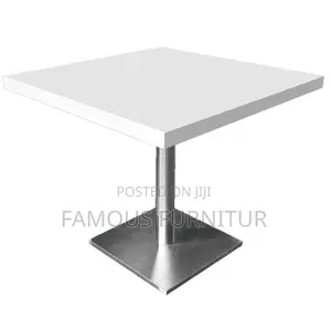 Modern Round Pedestal Restaurant Table With a White Top Square Base.