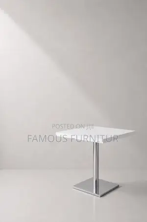 Modern Round Pedestal Restaurant Table With a White Top Square Base.