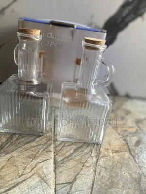 The Items in the Image Are a 2-Piece Glass Oil Dispenser Set.