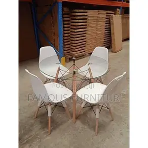 Round Glass-Top Dining Set With Four Eames-Style