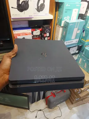 PlayStation 4 Slim With One Pad and 6 Games Including FC27