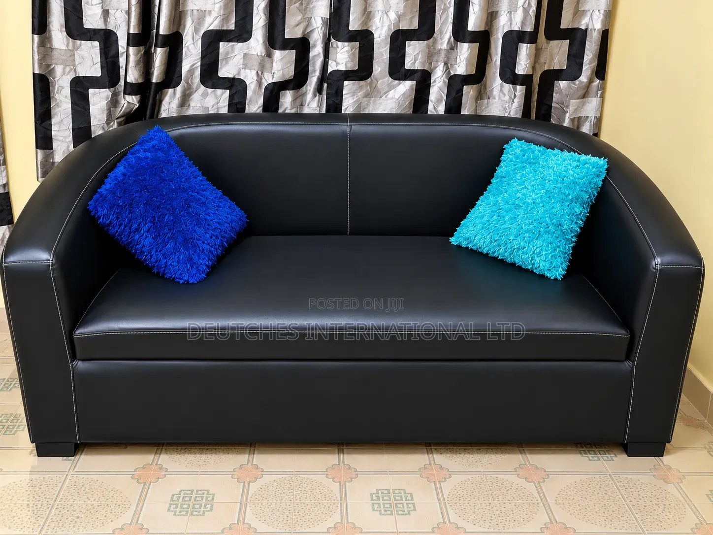 Black Leather Two-Seater Sofa – Fairly Used, Negotiable